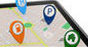 A tablet displaying a map with various icons representing important places marked on it